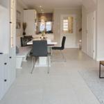 Living and dining area with TV, dining table, and kitchen area