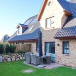House with terrace, garden, and umbrella. Wooden fence and stone wall surround the garden.