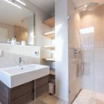 Bathroom with shower, sink, and mirror