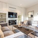 Living room with sofa, TV, and fireplace