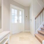 Entrance with stairs, bench, and French doors