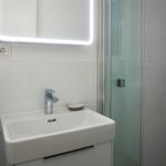 Bathroom with sink, mirror cabinet, and shower.
