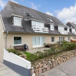 Holiday home with balconies and garden area on quiet street.