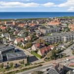 Panoramic view of coastal town with houses and sea