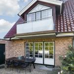 House with balcony, terrace, and outdoor dining area.