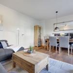 Living and dining area with sofa, table and chairs.