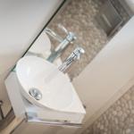 Sink with mirror and pebble tile wall