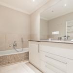 Bathroom with bathtub, mirror cabinet, and heater
