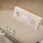 Shower cabin with modern control panel and mirror cabinet