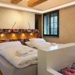 Bedroom with bed, headboard, and windows