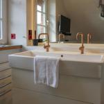 Bathroom with sink, mirror, and window