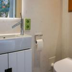 Bathroom with sink, mirror, and toilet.