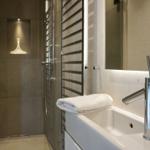 Bathroom with shower, sink, and towel
