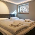 Bedroom with double bed, window, and bed linen.