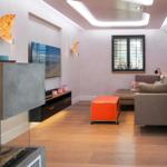 Living room with sofa, TV, and orange coffee table.
