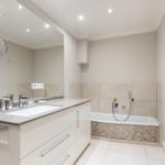 Bathroom with bathtub, sink and mirror
