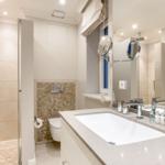 Bathroom with shower, sink, and toilet.