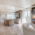 Living and dining area with fireplace, TV, and kitchen