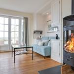 Living room with fireplace, sofa, and window view
