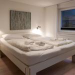 Bedroom with bed, window, and wall art.