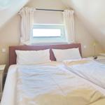 Bedroom with double bed, window, and nightstands
