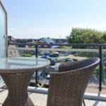 Terrace with wicker furniture and view of residential area