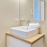 Sink with mirror and towel on wooden top