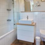 Bathroom with bathtub, shower, sink and toilet.