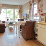 Living and dining area with kitchenette and view of the garden.