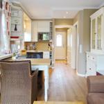Kitchen with dining table, living area, and hardwood floor