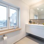 Bathroom with window, sink, and mirror