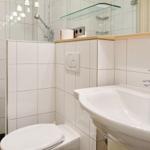 Bathroom with sink, toilet, and shower.