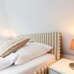 Double bed with pillows and nightstand with lamp