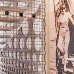 Netz vor moderner Wand mit runden Öffnungen und historischem Foto einer Frau am Wasser.