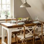 Dining table with four chairs and window view.