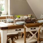 Wooden table with chairs and set table in dining area