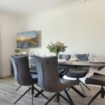Dining room with table, chairs, and wall picture.