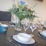 Set dining table with floral arrangement and dishes