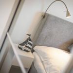 Bed headboard with nightstand and sailboat decoration