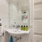 Bathroom with sink, mirror, and heater