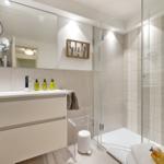 Bathroom with shower, sink, and mirror