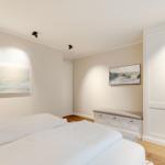 Bedroom with bed, wardrobe, and wall pictures