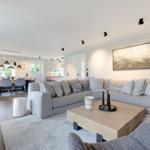 Living room with gray sofa, wooden table, and wall art.
