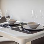 Table set with dishes and glasses for four people