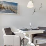 Dining table with two chairs, wall picture and wall decor