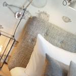 Bedroom with fish motifs on the wall and bedside lamp.
