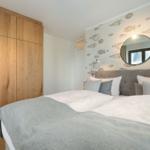 Bedroom with bed, wooden wardrobe, and fish wallpaper