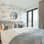 Bedroom with fish wallpaper, bed, and window