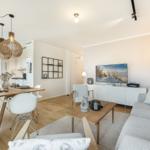 Living and dining area with sofa, dining table, and TV.