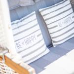 Sofa with cushions reading BE HAPPY